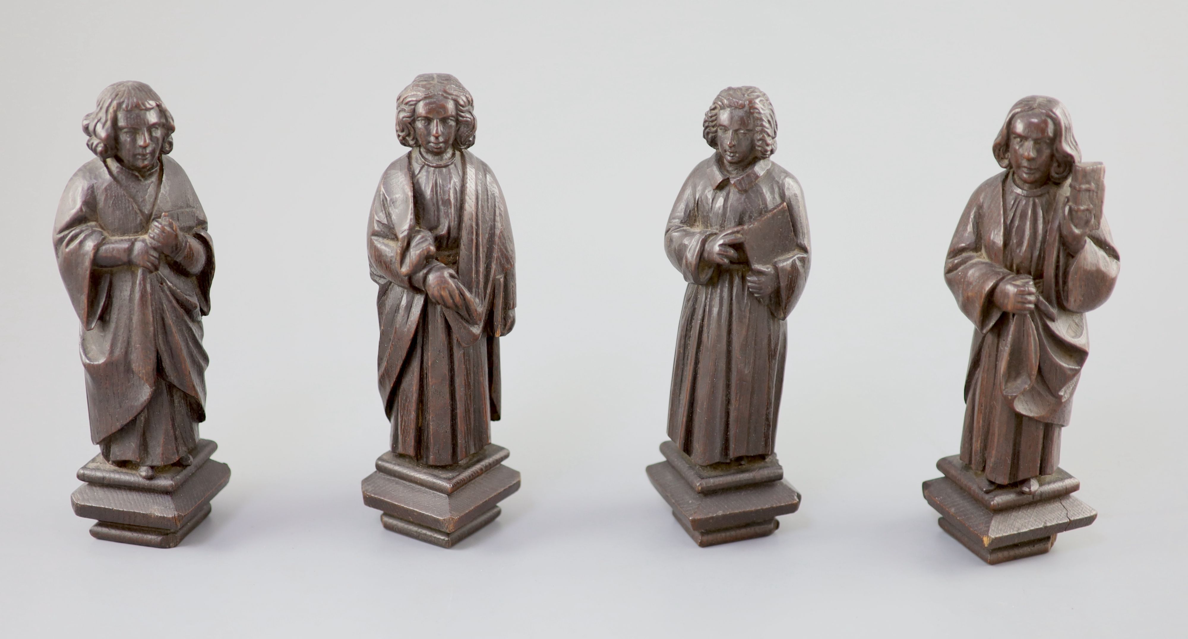 Four English oak figures of Evangelists, three possibly c.1425-50, one a 19th century copy, from Romsey Abbey? 19cm high Provenance - A